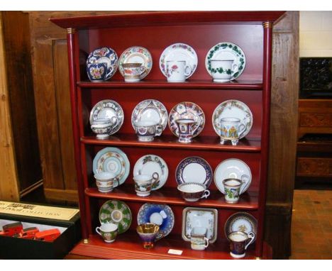 Miniature cups and saucers on display stand 