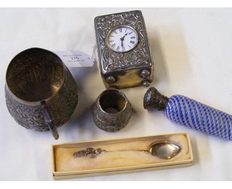 A small silver cased travelling clock, scent bottle etc.