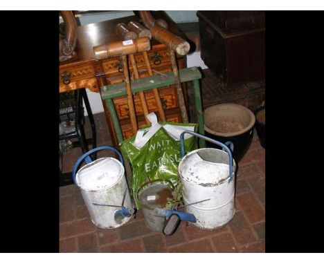 An old croquet set and three vintage watering cans