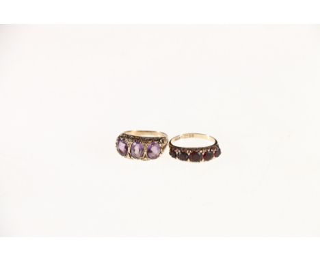 9ct gold garnet five stone dress ring size K, 2.6 grms and an unhallmarked yellow metal amethyst three stone ring size, 3.5 g