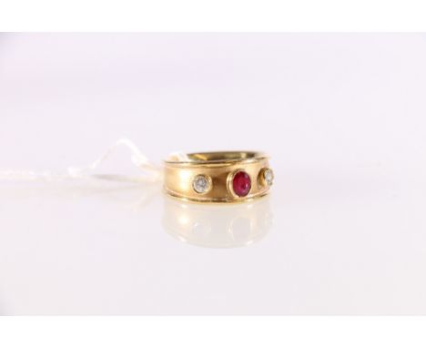 18ct yellow gold ring collet set with mixed cut ruby flanked by two brilliant cut diamonds.