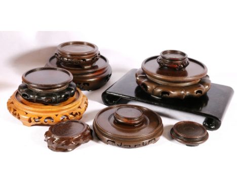 Group of eleven Chinese hardwood stands including a simple rectangular scroll foot stand. (11)