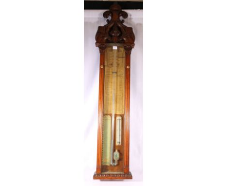 Admiral Fitzroy barometer in carved oak case with scroll surmount.
