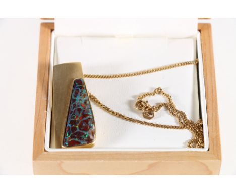 Yellow metal random shaped boulder opal pendant and 9ct Chain. 17.21grms.