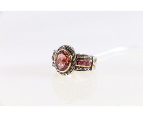 18ct Rose and white gold tourmaline, pink sapphire and diamond set dress ring. A centrally raised 18ct Rose gold rub-over and