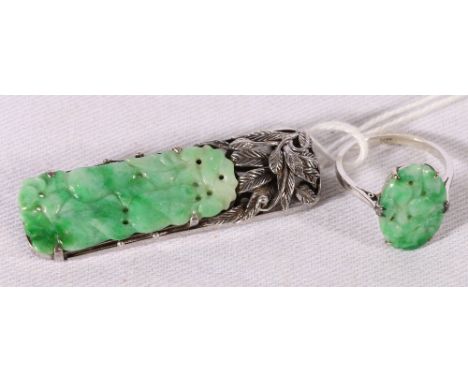 White metal ring set oval carved and pierced jade, stamped 9ct and a rectangular pierced jade brooch. (2) CONDITION REPORT: R
