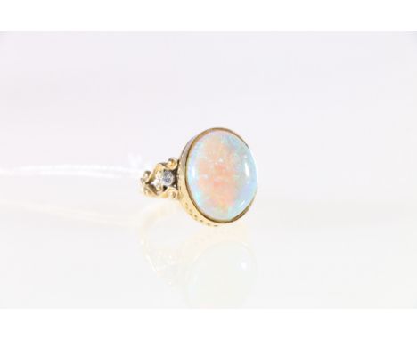 18ct yellow and white gold opal and diamond set cluster ring. large oval opal secured and portrait mounted in a double galler