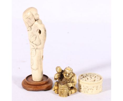 Japanese carved bone parasol handle depicting a monkey climbing on a tree trunk, a Chinese 19th century century carved ivory 