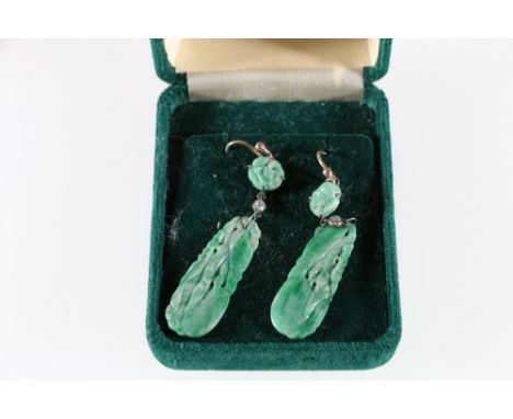 18ct yellow gold and platinum carved jade and diamond set drop earrings. These long carved mottled light green Jadeite panels