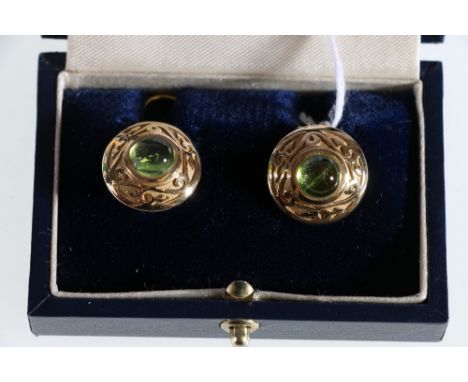 18ct yellow gold peridot cabochon earrings. circular shield shaped earrings each centre set in rub-over collets with a sugarl