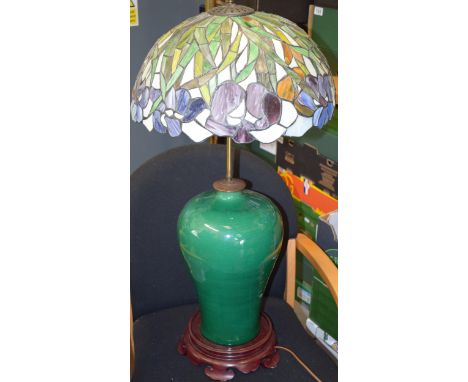 A late 20th century green crackle glaze freestanding lamp base, Chinese appearance, with Tiffany style lamp shade, 85cm tall.