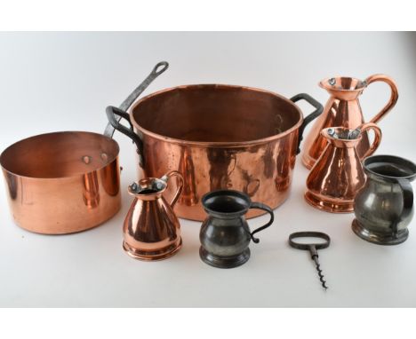 A good collection of 19th century and later metalware to include a large copper cooking pan, three graduated haystack jugs, t
