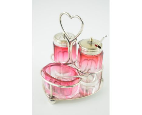 Silver plated cranberry glass cruet set, on plated hold, gradient colours, unmarked but possibly Bacarat.  In good condition 