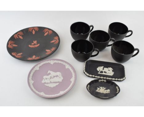 A Wedgwood plate, terracotta on black basalt with Egyptian design, a Lilac Mother plate, two black trays and a five black bas