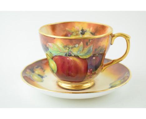 An R Everill (former Royal Worcester artist) breakfast cup and saucer with fruit scene, signed (2).  In good condition with n