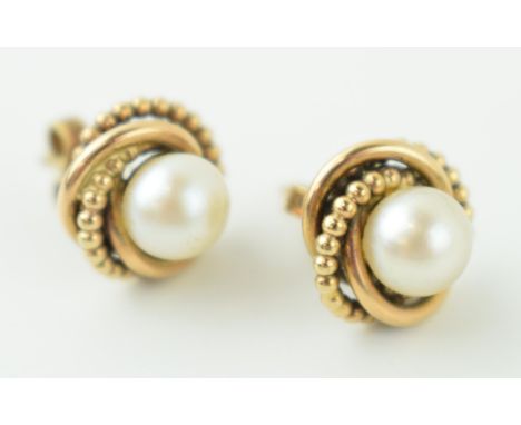 A pair of 9ct yellow gold pearl earrings. Weight 4.3 grams.