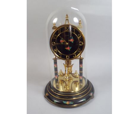 An Enamelled Brass Pillar Clock by Kundo. 