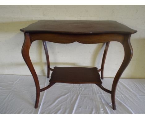 An Edwardian Walnut Occasional Table with Stretcher Shelf on Extended Cabriole Legs. 