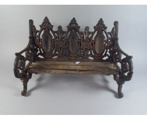 A Dolls Cast Iron Garden Bench.