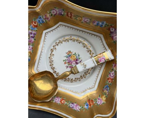 A French porcelain salad bowl, decorated with swags of flowers within a gilt border, inscribed to the reverse, with a matchin