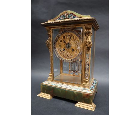 An early 20th century French gilt metal champleve enamel and onyx four glass mantle clock, of domed form the pilasters with h