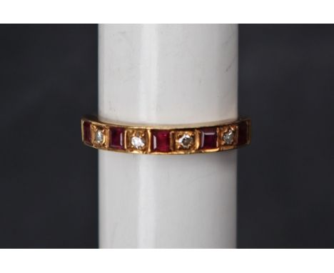 A ruby and diamond half eternity ring set with five princess cut rubies and four round brilliant cut diamonds to an 18ct yell