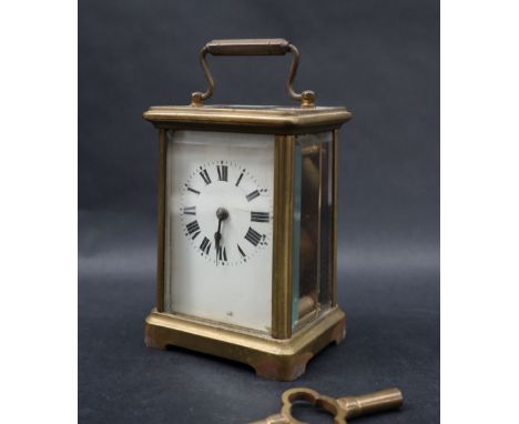 A brass cased carriage clock, with an enamel dial and Roman numerals, 14.5cm high 