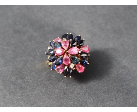 A ruby, sapphire and diamond cluster ring, set to a yellow metal setting and shank marked 18k, size P, approximately 7 grams