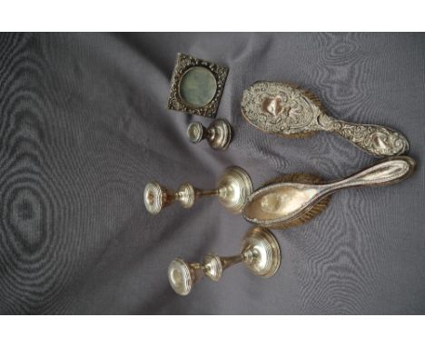 A pair of silver candlesticks, 18cm high, Birmingham, 1968 together with a silver desk candlestick, pair of silver hair brush