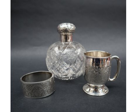 A late Victorian silver topped scent bottle, Birmingham, 1899 together with a silver christening mug and a white metal hinged