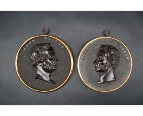 Two Bois Durci portrait roundels of "Richard Cobden" and "John Bright", in copper and brass frames, 12cm diameter