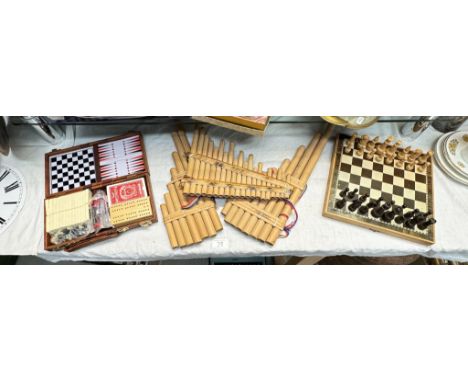 A boxed chess set, boxed compendium set and 3 slots of bamboo pan pipes