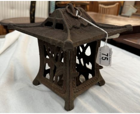 A cast iron Japanese tea light holder in the shape of a pagoda with foliage design to the panels. Top 20 x 20cm, Bottom 15 x 
