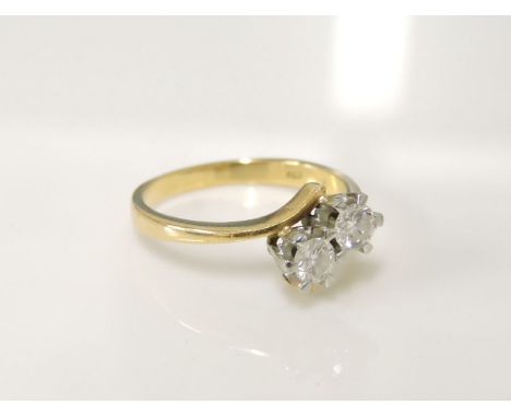 An 18ct gold two stone diamond crossover ring