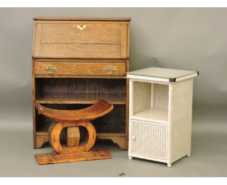 An African Ashanti stool, a Lloyd Loom bedside cabinet, and an oak bureau