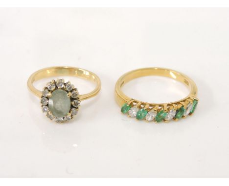 An 18ct gold aquamarine and diamond cluster ring, and an 18ct gold marquise cut emerald and diamond half eternity ring