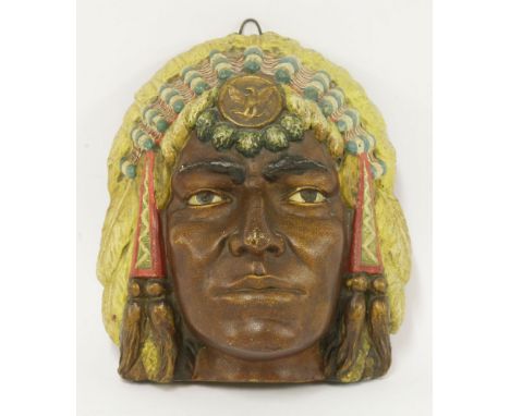 An Art Deco plaster bust of an Assiniboine Native American,inscribed '141 Copyright 1900 Assiniboine M.F.O.', with ring suspe