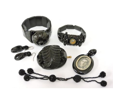 A jet graduated plaque bracelet, the centre panel set with a compass, a jet oval picture bracelet, a pair of jet earrings, a 