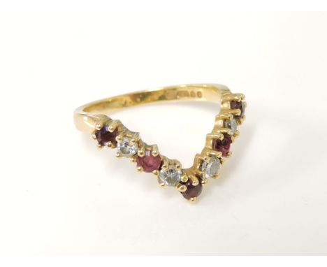 An 18ct gold ruby and diamond half wishbone ring