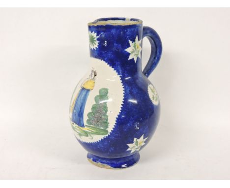A Delft powder ground jug, 19th century, centred with a girl smelling flowers, within a circular panel with further star-shap