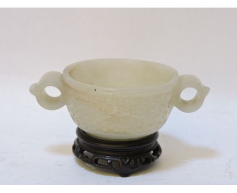 A jade two handled censer, 20th century, in the archaic style, wooden stand, 10cm long