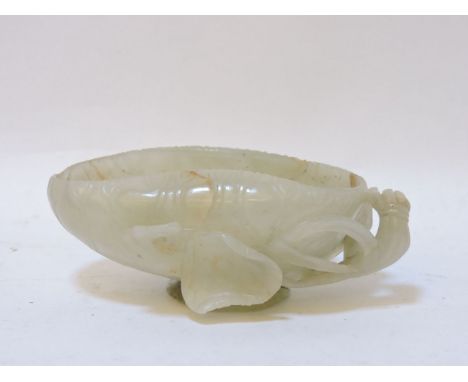A jade brush washer, 20th century, carved in the shape of a lotus leaf and stems, 11cm long