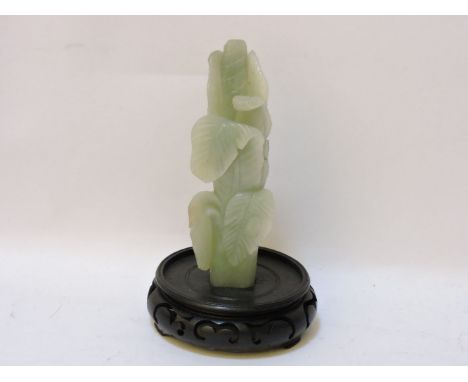 A jade carving of a lettuce, 20th century, with a cicada on one leaf, wooden stand, 18.5cm high