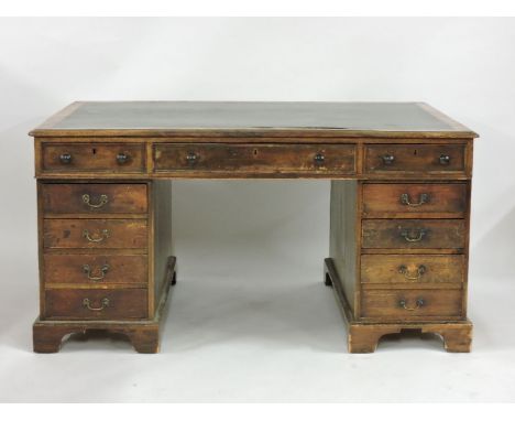 A 19th century mahogany partner's desk, the leather inset top over three short drawers and a further eight drawers around a k