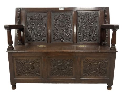 18th century design oak monks bench, the metamorphic top carved with three faux panels depicting scrolling foliate and seahor