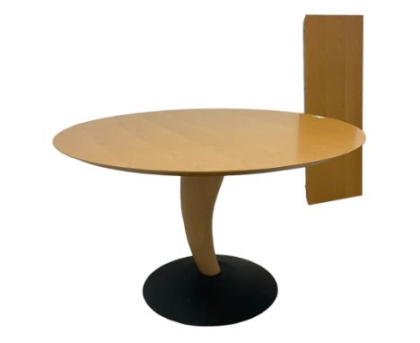 Contemporary light beech extending dining table, circular pull-out action top with additional leaf, on sculptural curved horn