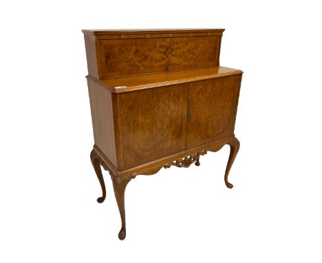 Mid-to-late 20th century figured walnut cocktail cabinet, raised upper section enclosed by hinged door, double cupboard below