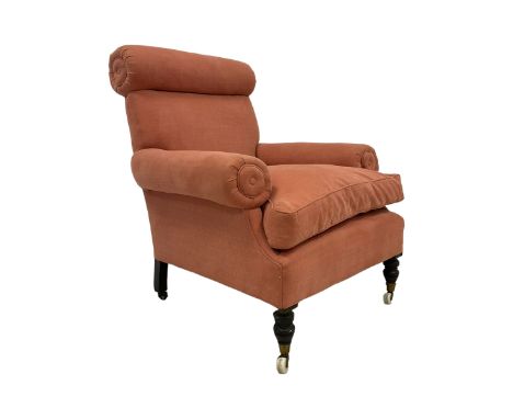 19th century hardwood-framed armchair, upholstered in salmon fabric with bolster arms and headrest, on ring turned feet  Dime