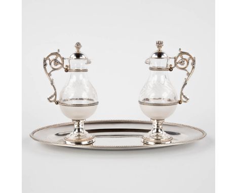 A pair of water and wine cruets, silver and glass.Marked with a Minerva, first grade silver.&nbsp;France, 19th/20th century.&