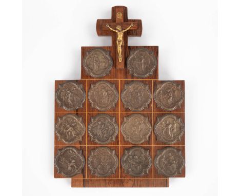 A wall plaque with 14 'Stations of the cross', medals and a crucifix.The first half of the 20th century.&nbsp;Dimensions:(W:2